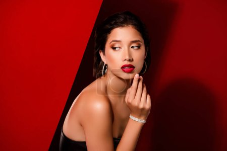 Photo for Photo of gorgeous korean young lady look seduce empty space wear black leather garment isolated on red color background. - Royalty Free Image