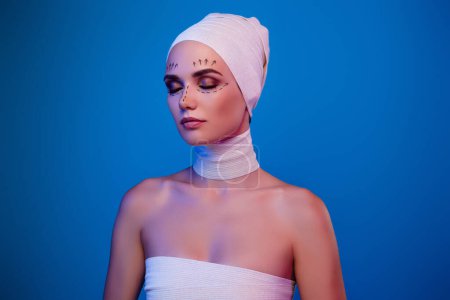 Photo for Photo of girl beauty salon client have plastic surgery wear medical bandage on head neck over vivid neon background. - Royalty Free Image