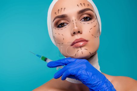 Photo for Photo of charming attractive patient girl hold in blue gloves syringe with botox isolated cyan color background. - Royalty Free Image