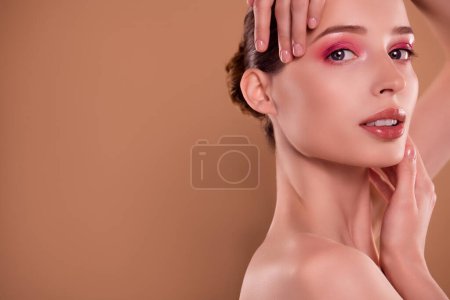 Photo for Photo of attractive gorgeous lady touch demonstrate glossy make up promoting beauty salon product on brown empty space. - Royalty Free Image