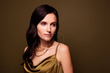 Photo for Wealthy luxurious elegant lady wearing khaki silky dress looking casino club offer on brown gradient color background. - Royalty Free Image