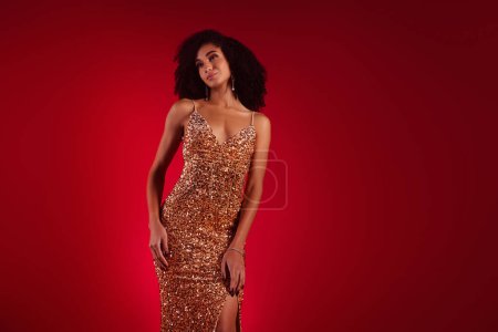Photo for Tempting slim lady wear sexy dress enjoying choosing new glamour look isolated on dark red color background. - Royalty Free Image