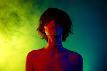 Photo for Photo of woman under colorful neon light cover close face with brown hair enjoy tenderness over bright background. - Royalty Free Image