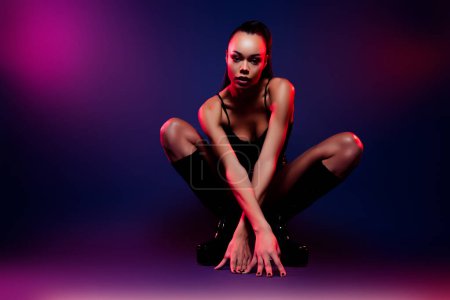 Photo for Photo of latin girl sit hands on floor moving dance isolated neon multicolor background. - Royalty Free Image