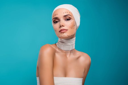 Photo for Photo of lady in medical bandage prepare for plastic operation to change face isolated cyan background. - Royalty Free Image