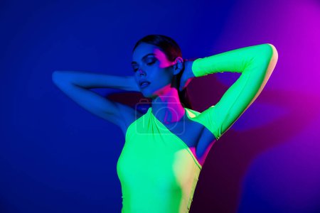 Foto de Portrait of pretty nice model girl hands touch head feel comfortable isolated on pink blue color neon background. - Imagen libre de derechos
