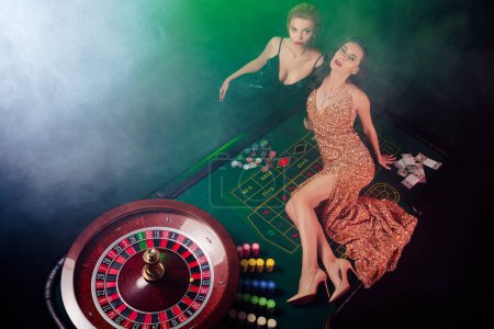 Photo for Top photo of tempting hot vip girls enjoy holiday in casino club playing poker winning black jack lying table. - Royalty Free Image