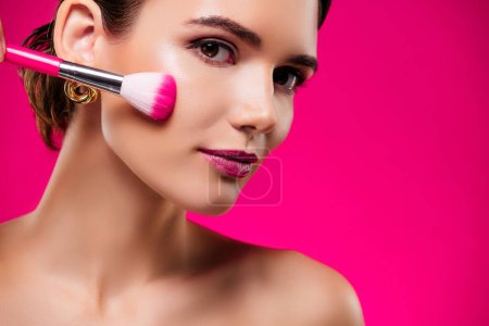 Photo for Photo portrait of attractive young woman apply brush face shoulders off isolated on pink color background. - Royalty Free Image