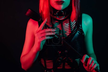 Photo for Woman with a sexy body in beautiful underwear holds a leather flogger whip in her hand for BDSM sex with domination and submission - Royalty Free Image