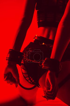 Photo for Sexy ass of a submissive slave girl woman with hands in BDSM handcuffs - Royalty Free Image