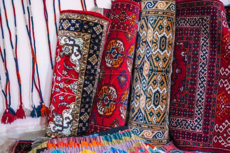 Photo for Stack of rolled up traditional oriental uzbek handmade carpets at the market in Uzbekistan in Tashkent - Royalty Free Image