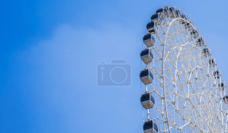 white big Ferris wheel on background a clear blue sky in fair in summer with copy space