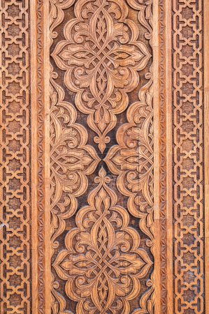 tajik kandakori patterns arabesque ornament on an vintage wooden carved door in Tajikistan closeup