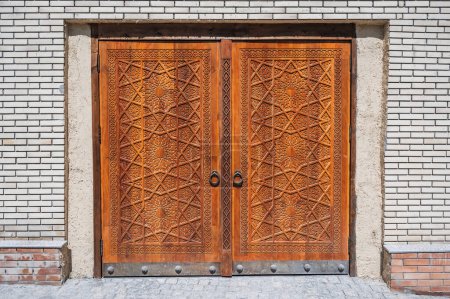 modern carved wooden gate with Islamic Uzbek carved pattern with stars ornament in oriental style in Uzbekistan in Tashkent