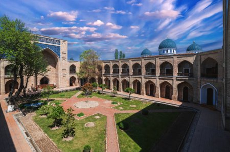 courtyard with cells of ancient Uzbek islamic Kukeldash madrasah in Tashkent in Uzbekistan. Old medieval Islamic madrassa in spring day