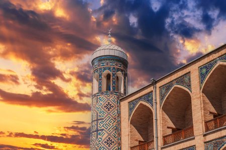 Photo for Brick walls decorated with ceramic tiles with oriental pattern of Kukeldash madrasah in Uzbekistan in Tashkent. Ancient old Islamic madrassa on the background of the sunset sky - Royalty Free Image
