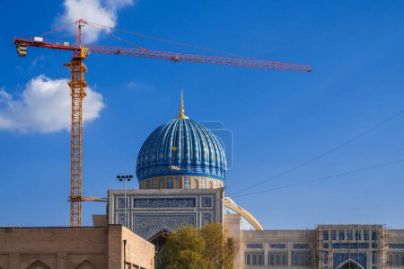 Photo for Crane on a construction site is building a new large mosque Center of Islamic Civilization in Tashkent in Uzbekistan - Royalty Free Image