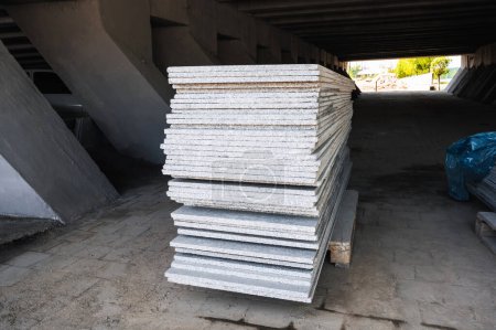 stack of white marble slabs on construction site for the decoration of facade of building