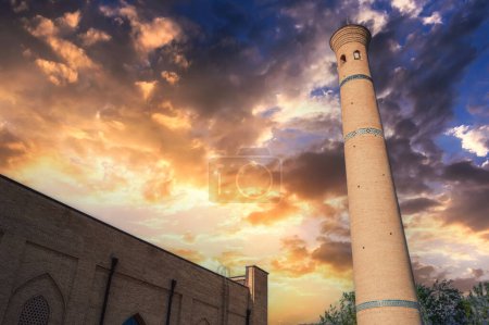 ancient old minaret of the Hast Imam mosque on background at beautiful sunset sky in summer. Islamic architectural complex Hazrati Imam in Tashkent in Uzbekistan