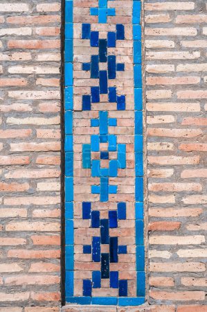 traditional Arabic Uzbek ceramic tile patterns on the brick wall of ancient Islamic Kukeldash Madrasah in Tashkent in Uzbekistan