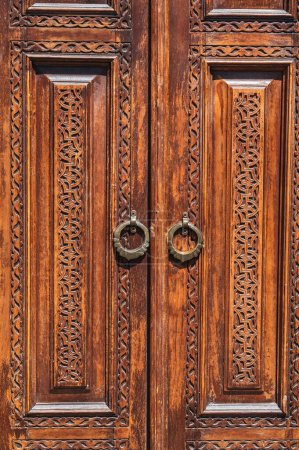 traditional Asian Uzbek patterns arabesque ornament on an ancient wooden carved door in Uzbekistan close-up