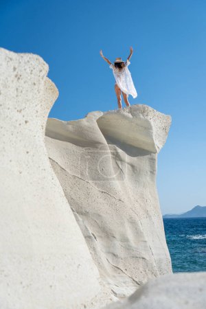 Photo for Model on top of a cliff in Sarakiniko, Milos Island - Royalty Free Image