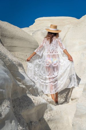 Photo for Model playing with her dress on Sarakiniko beach, Milos Island - Royalty Free Image