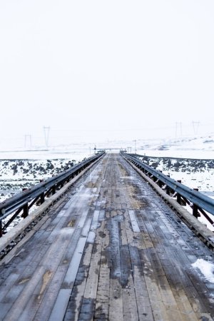 Wooden bridge in Iceland after a snowfall