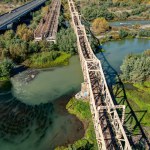 Aerial view of the railroad bridge above a river in Maule region, Chile. Top view of the railroad from drone