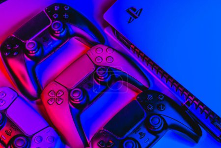 close - up of the joystick in the neon light, playstation 5 and controllers, gamer background, console and gamepads