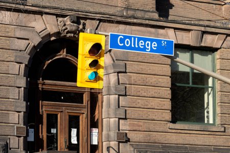 Photo for Toronto, Canada - November 9, 2020: College Street sign with traffic light is seen in downtown Toronto, Canada. College Street is a principal arterial thoroughfare in downtown Toronto. - Royalty Free Image
