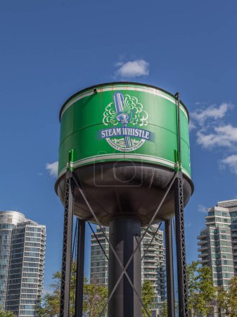 Foto de Toronto, Canadá - 24 de junio de 2017: El tanque de agua verde con el cartel de pilsner premium de Canadá junto a Steam Whistle Brewing Roundhouse en Toronto, la cervecera artesanal independiente más grande de Canadá. - Imagen libre de derechos
