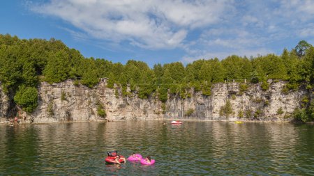 Photo for ELORA, ONTARIO, CANADA - JULY 30, 2016: People swimming in Elora Quarry conservation area. Known as old swimming hole, this two acre former limestone quarry is encircled by 12 m high sheer cliffs. - Royalty Free Image