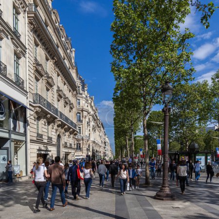 Photo for PARIS, FRANCE- MAY 7, 2016: People walking on the Avenue des Champs-Elysees , an famous avenue in Paris, 1.9 kilometers long. - Royalty Free Image