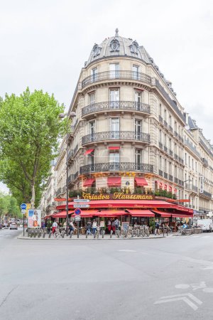 Photo for PARIS, FRANCE- MAY 8, 2016: People eating and drinking at the restaurant located at the corner of the street in Paris. - Royalty Free Image