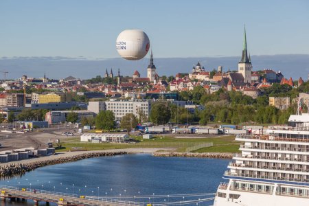 Photo for TALLINN, ESTONIA - MAY 16, 2016: Cruise ship in port of Tallinn, Estonia on May 16, 2016 with old town and balloon in background. - Royalty Free Image