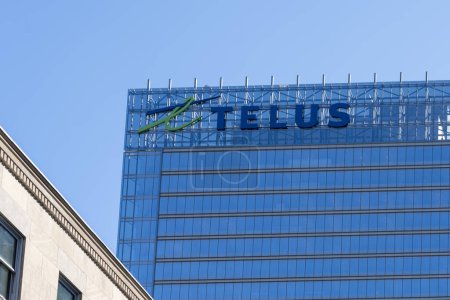 Photo for Telus logo is seen on Telus Harbour building at 25 York Street in downtown Toronto, ON, Canada, on October 22, 2023. Telus Corporation is a Canadian publicly traded holding company and conglomerate. - Royalty Free Image