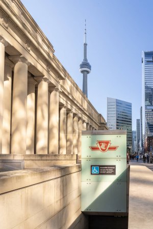 Photo for TTC (Toronto Transit Commission) logo is seen outside the Union Station building with the CN tower background in Toronto, ON, Canada, on October 22, 2023. TTC is the public transport agency. - Royalty Free Image