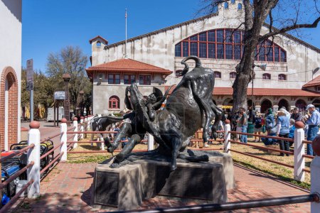 Foto de Fort Worth, Texas, Estados Unidos - 19 de marzo de 2022: La estatua de Bill Pickett frente al Cowtown Coliseum en Fort Worth Stockyards, Texas, Estados Unidos. Fort Worth Stockyards es un distrito histórico nacional. - Imagen libre de derechos