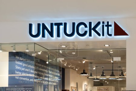 Foto de Houston, Texas, EE.UU. - 25 de febrero de 2022: letrero de primer plano Untuckit que se muestra sobre la entrada de la tienda en un centro comercial. Untuckit LLC es una compañía estadounidense de ropa casual para hombres.. - Imagen libre de derechos