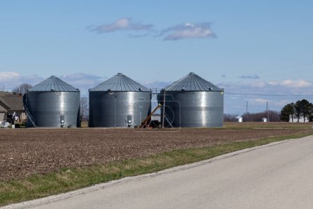 Téléchargez les photos : Illinois, États-Unis - 26 mars 2022 : Des cellules de stockage GSI sont visibles dans la ferme de l'Illinois, aux États-Unis. GSI est un fabricant américain de bacs de ferme en acier, bacs à grains de stockage, silos à grains et plus. - en image libre de droit