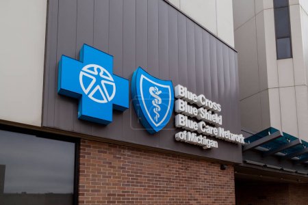 Photo for Lansing, Michigan, USA - March 30, 2022: Closeup sign for Blue Cross, Blue Shield and Blue Care Network of Michigan on their office in Lansing, Michigan, USA. - Royalty Free Image