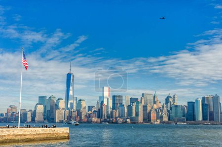 Téléchargez les photos : NYC Cityscape with Liberty Island And Waving Flag. USA - en image libre de droit