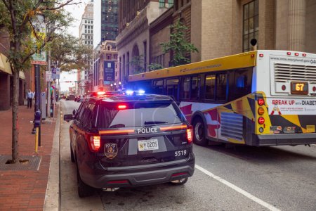 Photo for Baltimore, Maryland - October 03, 2019: Baltimore Police Vehicle with Flashing Lights On. Cityscape in Background. - Royalty Free Image