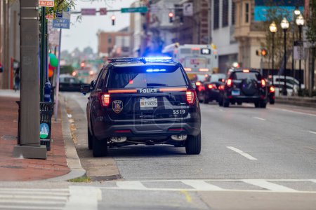 Photo for Baltimore Police Vehicle with Flashing Lights On. Cityscape in Background. - Royalty Free Image