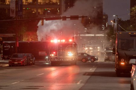 Photo for Baltimore, Maryland - October 03, 2019: Traffic in Baltimore with Vehicles and Fire Department Vehicle with Flashing Lights in Background. - Royalty Free Image