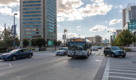 Photo for Baltimore, Maryland - October 04, 2019: Traffic in Baltimore, Maryland. City Street and Public Transport Bus in Action. USA - Royalty Free Image