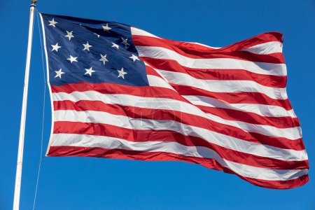 Téléchargez les photos : USA Flag Waving in Blue Background. Clear Blue Sky. American Wave Flag - en image libre de droit
