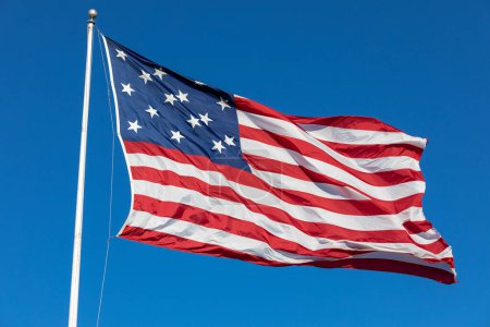 Téléchargez les photos : USA Flag Waving in Blue Background. Clear Blue Sky. American Wave Flag - en image libre de droit