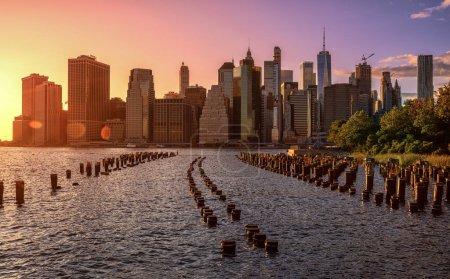Photo for NYC Cityscape in Sunset Light. Old Pier in Foreground. Lower Manhattan Cityscape in Background. Skyscraper - Royalty Free Image